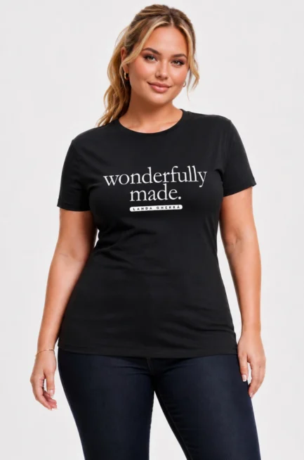 Beautiful plus size Caucasian woman wearing a black crew neck, relaxed fit t-shirt with the words "Wonderfully Made" on the front chest